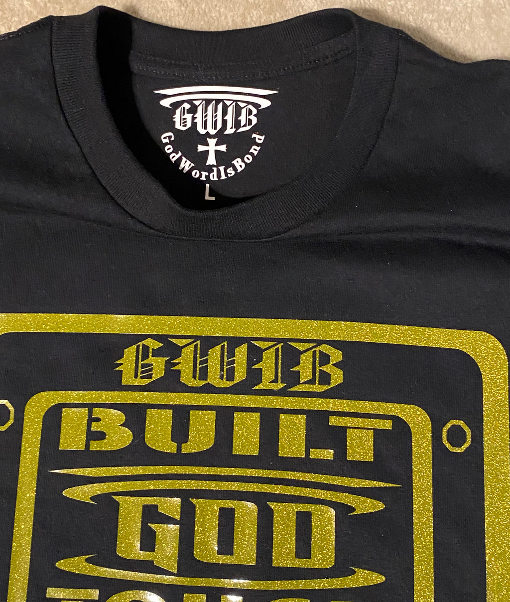Built God Tough T shirt in black with a gold glitter design.